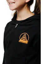A smiling girl wearing the Youth Black & Orange Logo Zip-Up Hoodie, adorned with a golden bridge logo and San Franspycho text, made from 100% cotton.