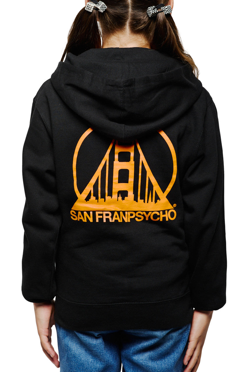 A child is wearing the Youth Black & Orange Logo Zip-Up Hoodie, which is crafted from 100% cotton and features an orange bridge logo and "San Franpsycho" on the back.