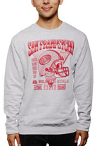 A man wearing the Candlestick Champs Crewneck, a vintage gray sweatshirt featuring San Fransycho and football graphics in red, is perfect for Niners season. This unisex crewneck seamlessly blends style with team spirit.