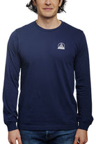 A person models the Navy Long Sleeve Mini Logo tee made from soft Airlume cotton with a small white logo, paired with jeans, set against a white background.