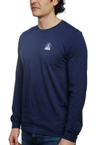 A man wears the Navy Long Sleeve Mini Logo tee, crafted from soft airlume cotton, with a small white logo on the chest, against a white background.