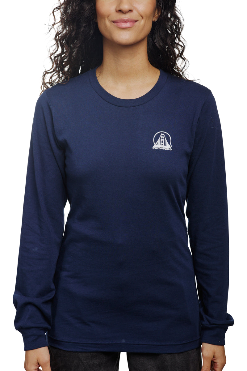 A smiling person wears the Navy Long Sleeve Mini Logo tee, crafted from soft airlume cotton, with a subtle chest logo.