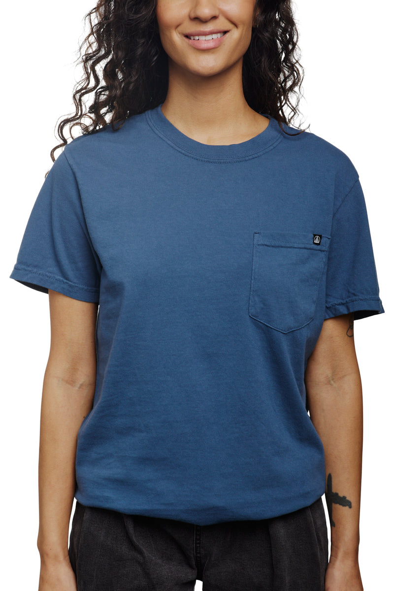 A smiling person with long hair is wearing a Heavyweight Midnight Pocket Tee.