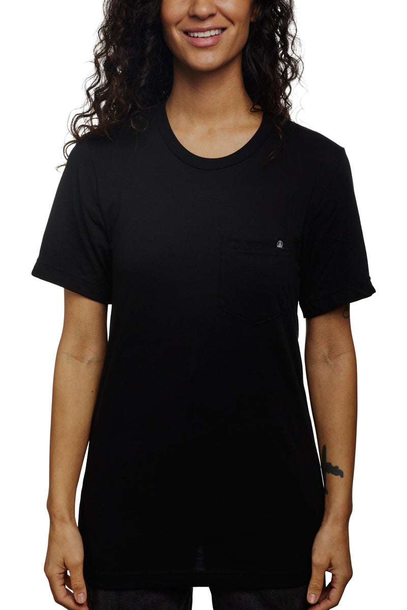 A smiling person with long hair stands against a white background, wearing the Black Pocket Tee w/ SFP Clip Label, crafted from soft Airlume cotton.
