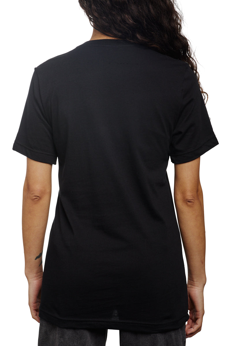 A person with long hair is wearing a Black Pocket Tee w/ SFP Clip Label, facing away from the camera.