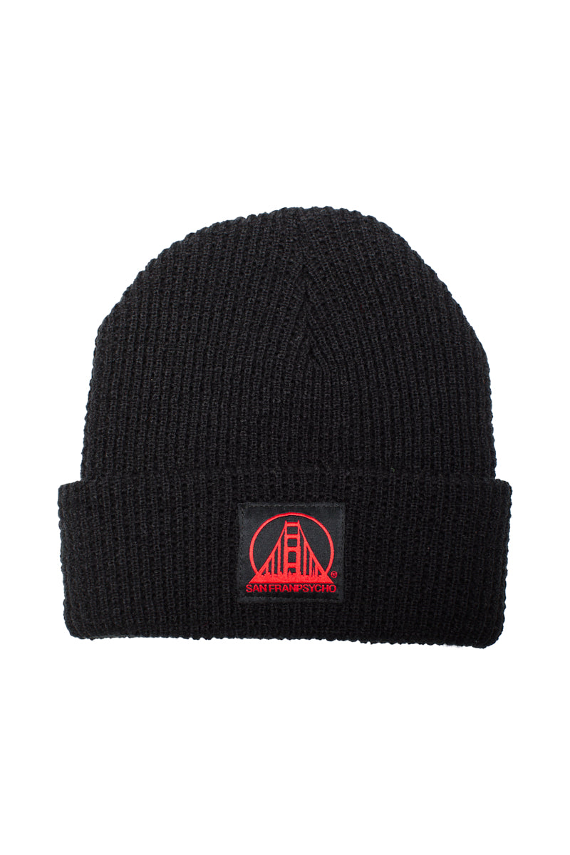 The Black Waffle Beanie w/ Black/Red SFP Logo features a comfy acrylic build with a red patch showing a bridge and San Franpsycho text on the front cuff, bringing iconic city style to your look.