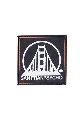 The SFP Logo Patch is an embroidered black patch featuring a stylized bridge design with crisp white "SAN FRANPSYCHO" text, ideal for use as an iron-on accessory.